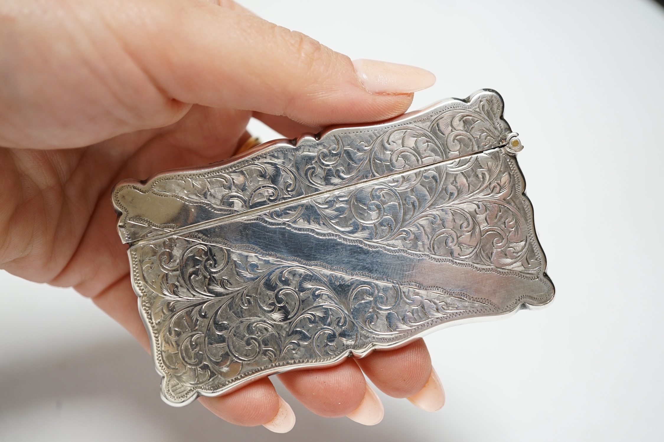 Five assorted silver topped glass toilet jars, a silver compact and an Edwardian engraved silver card case, Birmingham, 1902, 83mm.